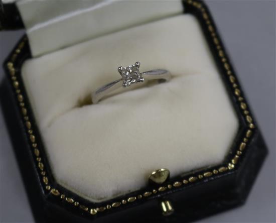 A princess-cut diamond solitaire ring, platinum setting and shank.